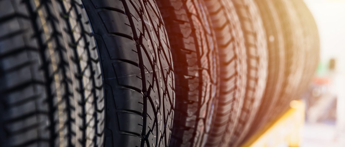 Car tires on shelf in garage shop for sale various type of tyre.